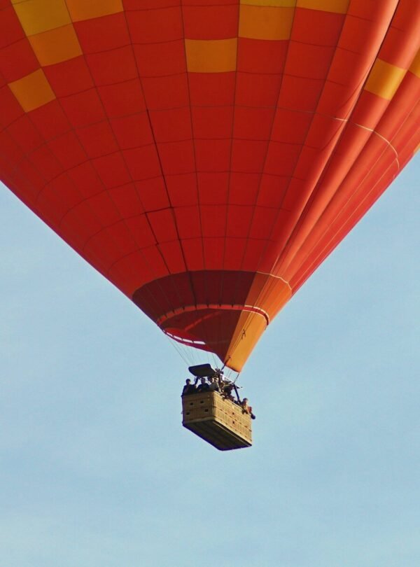 a large hot air balloon flying through a blue sky