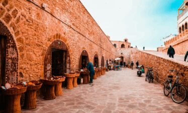 people walking on brown brick building during daytime